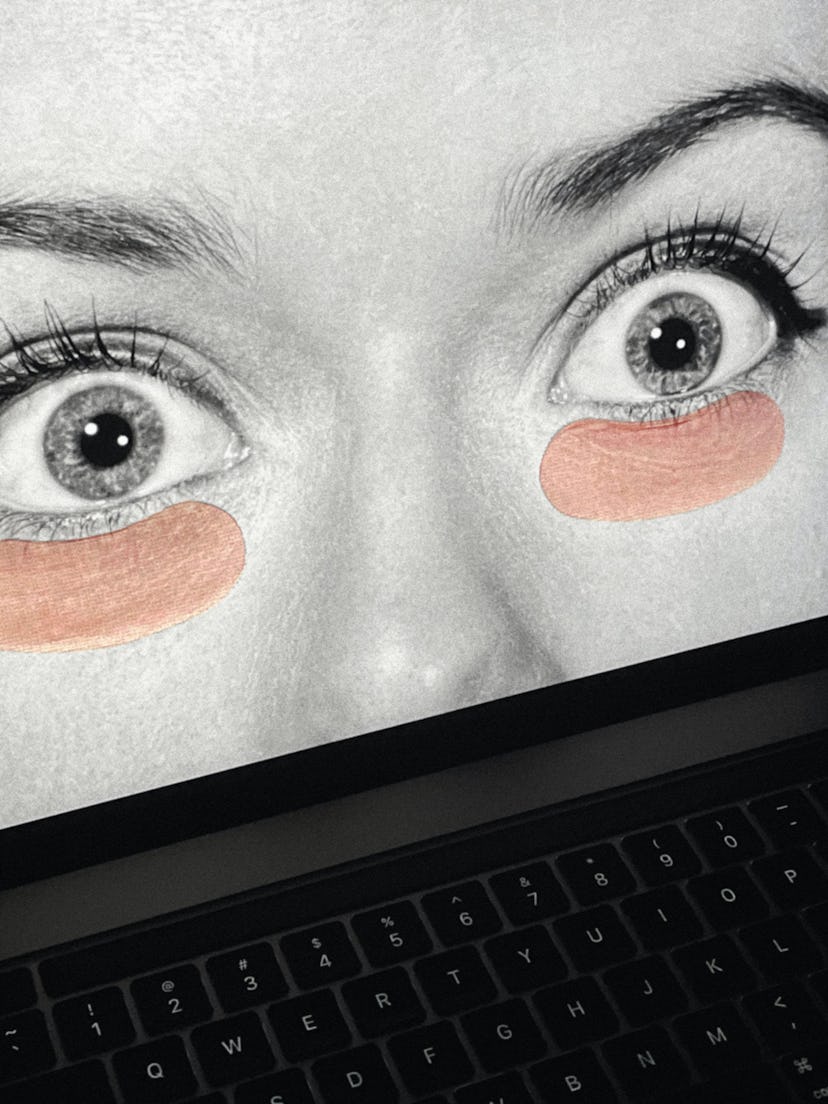 A woman widening her eyes with under-eye masks