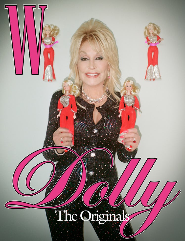 Dolly Parton in a black shimmer tweed jacket and trousers on the cover of W, holding dolls