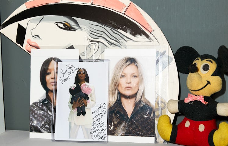 Photos of Kate Moss and Naomi Campbell and a Mickey Mouse plush toy on a shelf