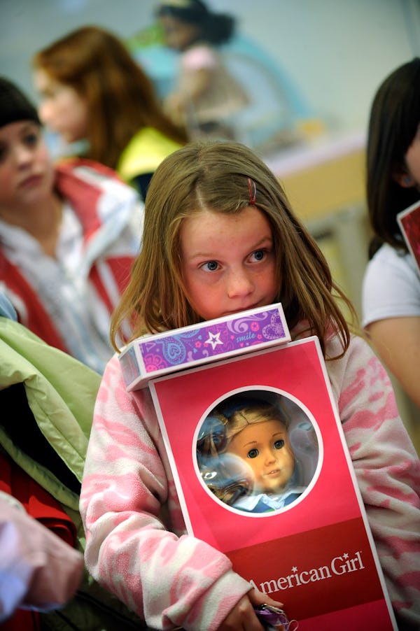 Mary Frances, 8, of Littleton waits to by a new doll named Lanie, during the grand opening of Americ...