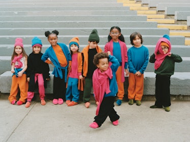 Children wearing pink, orange, black and blue clothes by The Row