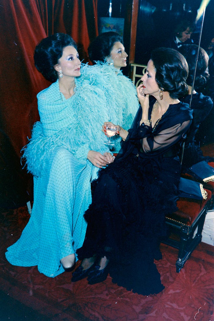 Jacqueline de Ribes and Gloria Guinness in a blue and a black gown