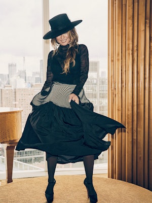 Shania Twain in Issey Miyake top and a Eugenia Kim hat all in black