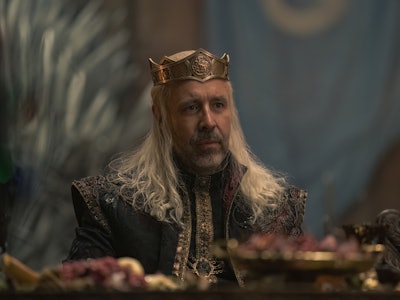 King Viserys I Targaryen (Paddy Considine) sits at a banquet table in House of the Dragon Episode 5