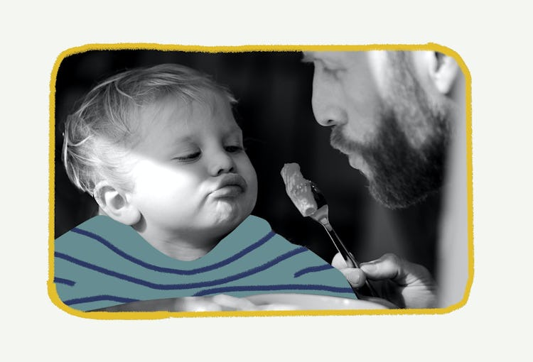 Father feeding baby with  food on a fork