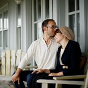 Couple consoling one another on front porch