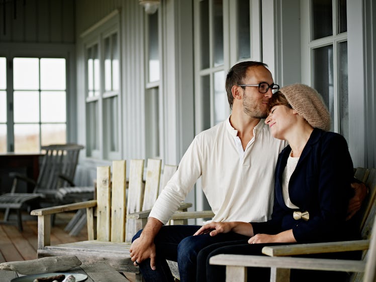 Couple consoling one another on front porch