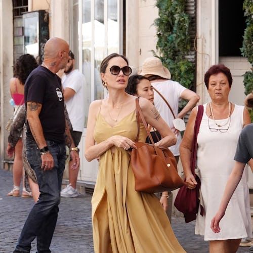 Angelina Jolie carrying a brown Celine tote bag.