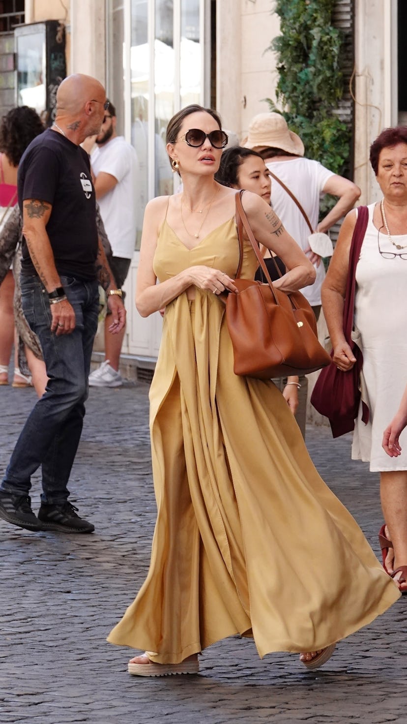 Angelina Jolie carrying a brown Celine tote bag.