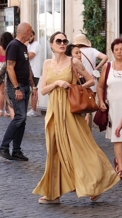 Angelina Jolie carrying a brown Celine tote bag.