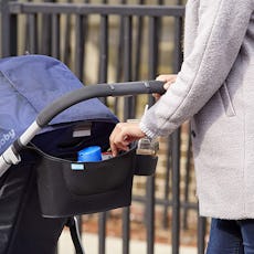 A Woman Pushing A Stroller While Using the Stroller Organizer 