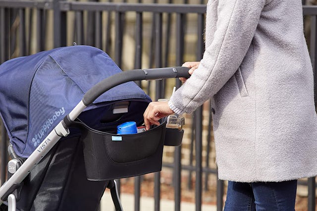 A Woman Pushing A Stroller While Using the Stroller Organizer