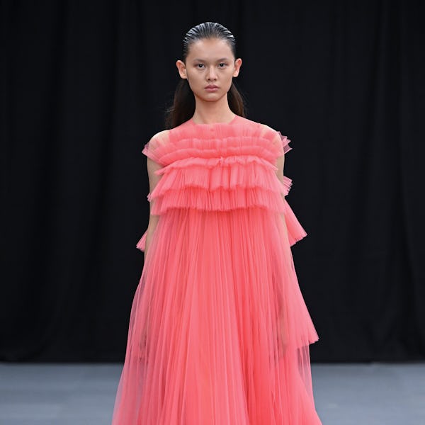 A model walks the runway in a peach-colored tulle dress by Huishan Zhang.
