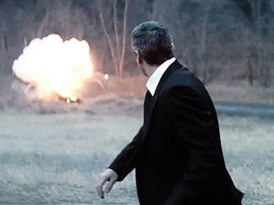 George Clooney in the movie Michael Clayton staring back at an explosion.