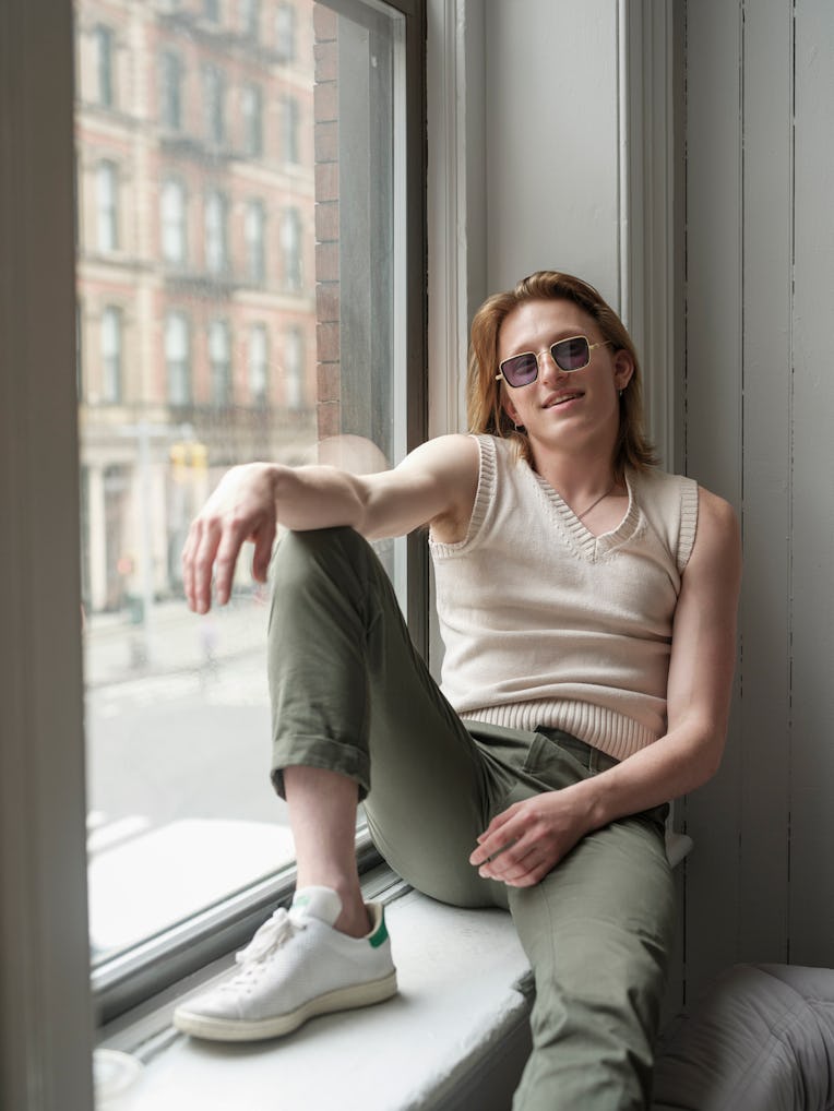 Ben Hard sitting on a windowsill