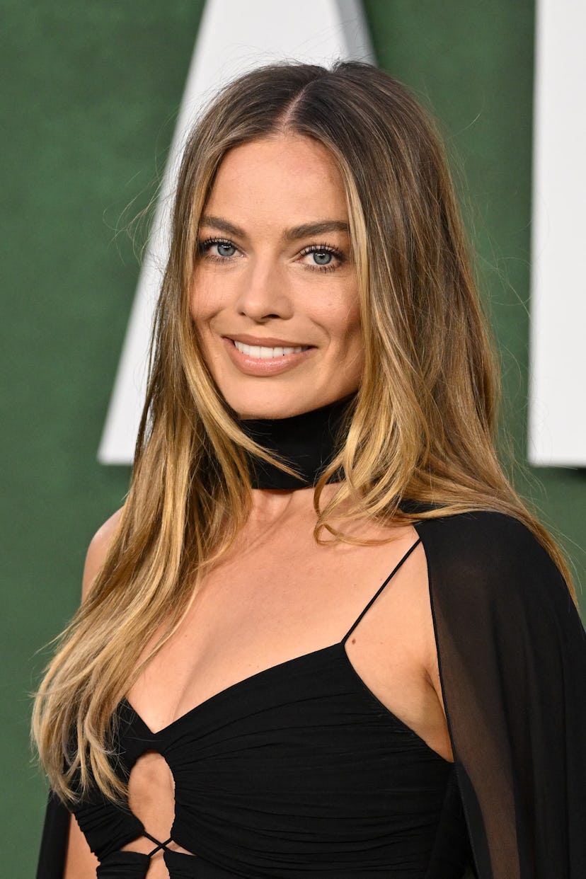 Margot Robbie at the premiere of Amsterdam wearing a black dress with choker