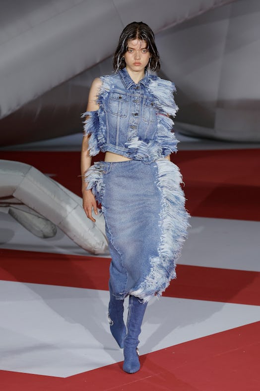 A model in a denim waistcoat and dress at the Diesel Fashion Show during the Milan Fashion Week Wome...
