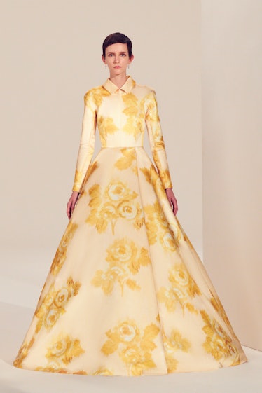 A female model walking in a yellow floral Emilia Wickstead gown