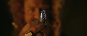 Prince Durin IV (Owain Arthur) holds up a piece of mithril in The Lord of the Rings: The Rings of Po...
