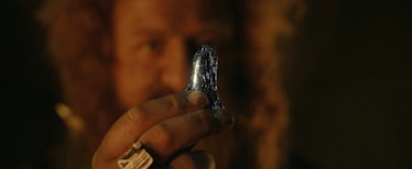 Prince Durin IV (Owain Arthur) holds up a piece of mithril in The Lord of the Rings: The Rings of Po...
