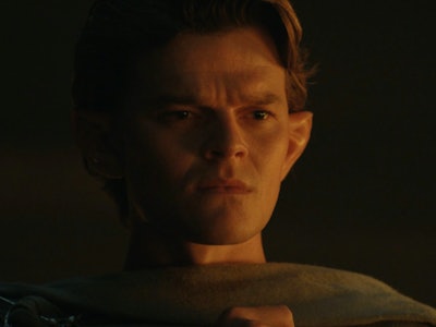 Elrond (Robert Aramayo) looks down in confusion in The Lord of the Rings: The Rings of Power Episode...