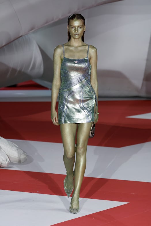 A model in a silver dress at the Diesel Fashion Show during the Milan Fashion Week Womenswear Spring...