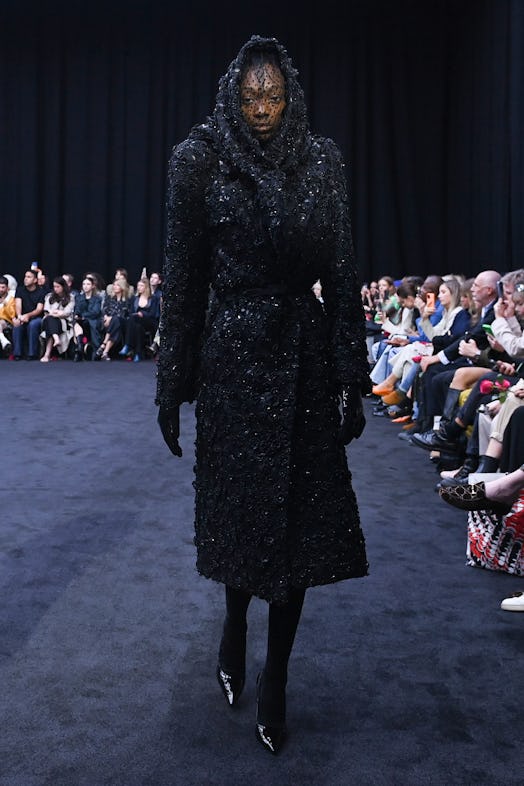 A model wearing Richard Quinn’s sequined black coat that pays tribute to Queen Elizabeth II.