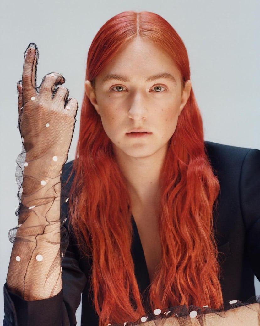 A red-haired Harris Reed wearing a black tulle glove by Nina Ricci