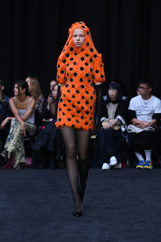 Richard Quinn’s orange feather dress with black circles tributing Queen Elizabeth II.