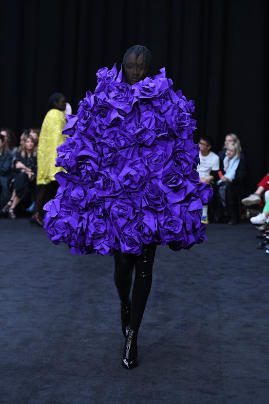 Richard Quinn’s edgy rose-shaped puffy dress in the deep purple color as a tribute to Queen Elizabet...