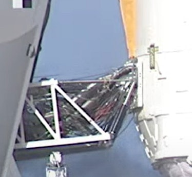 photo of scaffolding connected to the side of a rocket