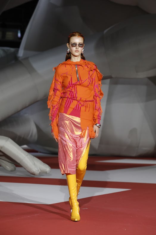 A model in an orange jacket and skirt at the Diesel Fashion Show during the Milan Fashion Week Women...