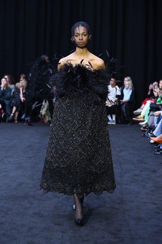 A black feather & sequins dress look designed by Richard Quinn as a tribute to Queen Elizabeth II.