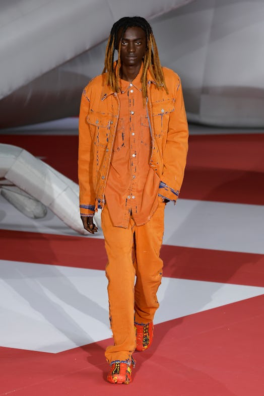 A model in an orange suit at the Diesel Fashion Show during the Milan Fashion Week Womenswear Spring...