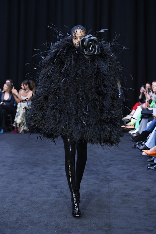 Oversized feather dress with the statement big black rose detail as Richard Quinn’s tribute to Queen...