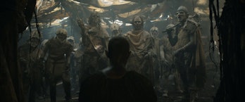 Arondir (Ismael Cruz Córdova) kneels before a group of orcs in The Lord of the Rings: The Rings of P...
