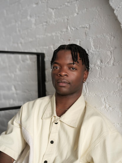 Taofeek Abijako, star of Freeform's 'The Come Up,' wearing white against a white brick backdrop.