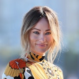 A smiling Olivia Wilde wearing a floral dress
