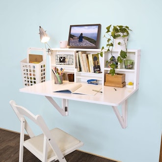 This floating desk folds down flat and has small shelves above it.
