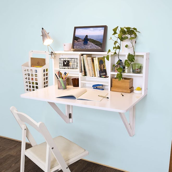 This floating desk folds down flat and has small shelves above it.