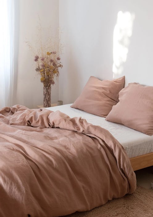 A bed with the Sunset Rose Linen Bedding Set