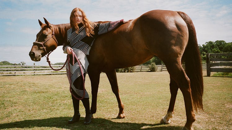 Sadie Sink putting her arm on a horse in a Stella McCartney campaign