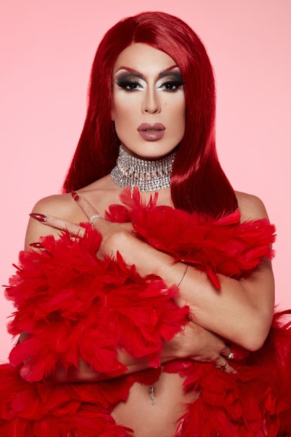 Alaska 5000 wearing a red feather boa with matching red hair
