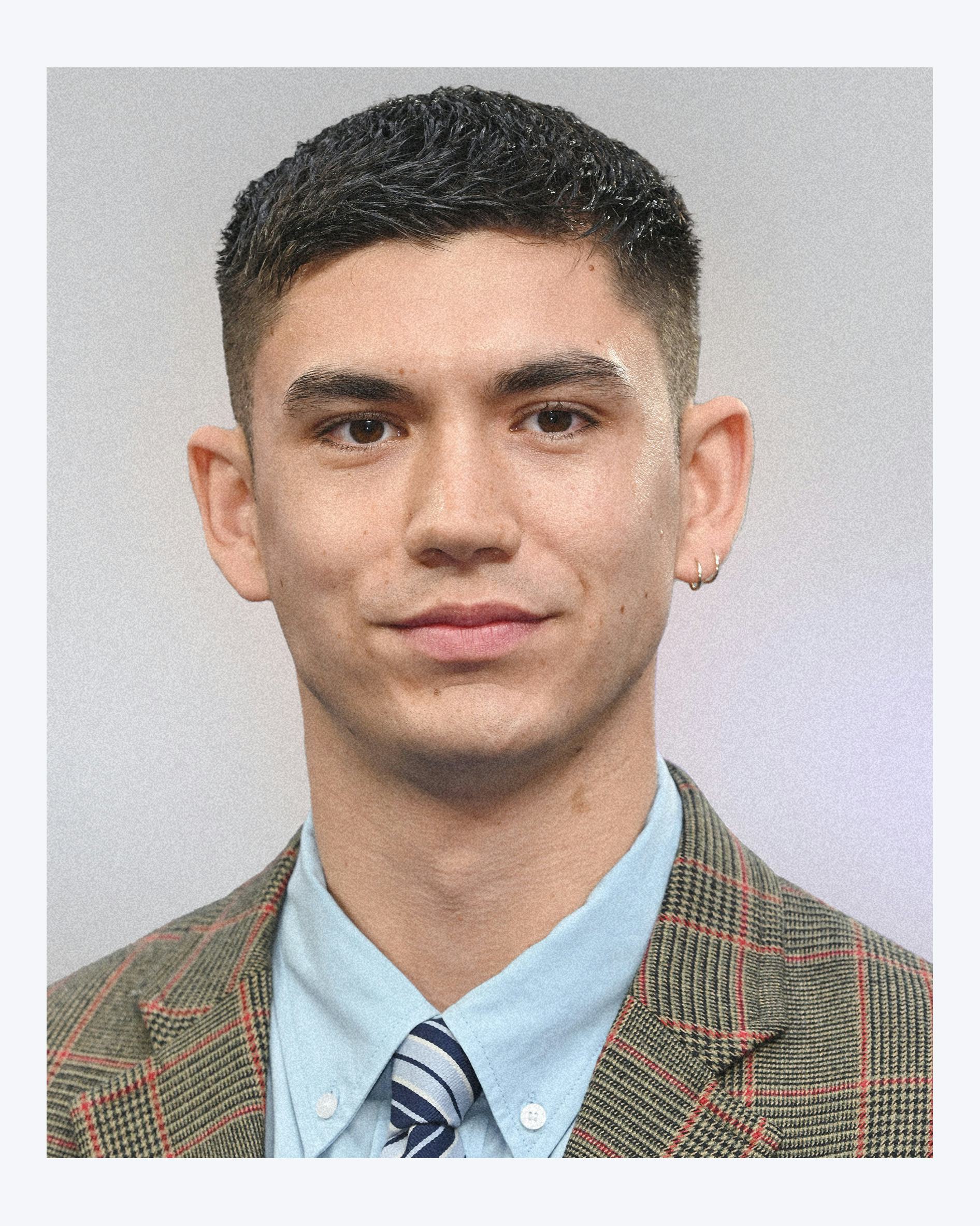 A photo of Archie Renaux wearing a plaid suit