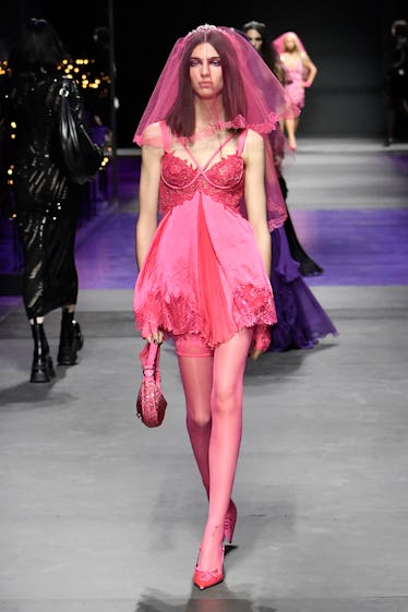 Goths, Bride-to-bes, and Directional Purple 21 A model walks the runway during the Versace Ready to Wear Spring/Summer 2023 fashion show as part of...
