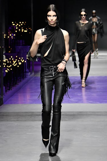 Goths, Bride-to-bes, and Directional Purple 4 A model walks the runway during the Versace Ready to Wear Spring/Summer 2023 fashion show as part of...