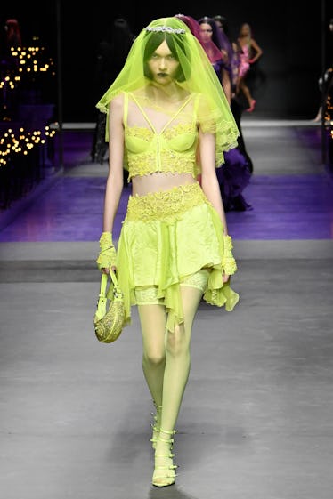 Goths, Bride-to-bes, and Directional Purple 20 A model walks the runway during the Versace Ready to Wear Spring/Summer 2023 fashion show as part of...
