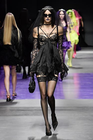 Goths, Bride-to-bes, and Directional Purple 8 A model walks the runway during the Versace Ready to Wear Spring/Summer 2023 fashion show as part of...