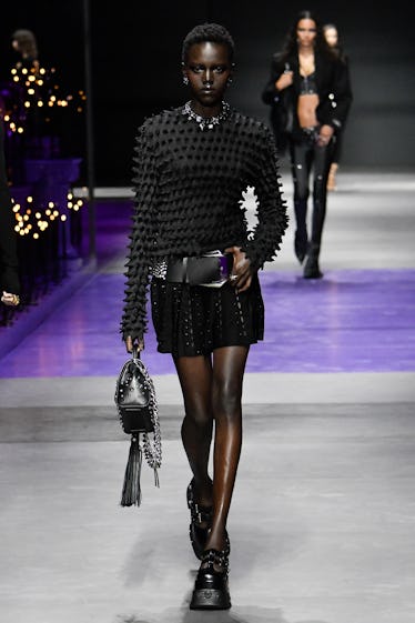 Goths, Bride-to-bes, and Directional Purple 9 A model walks the runway during the Versace Ready to Wear Spring/Summer 2023 fashion show as part of...