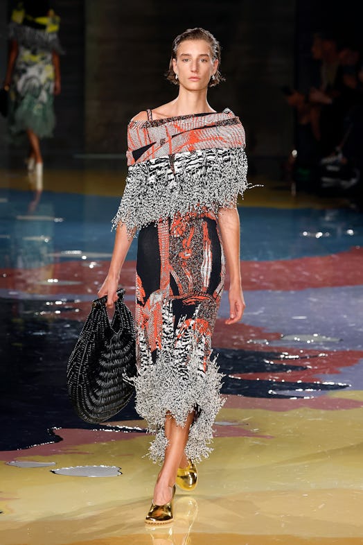 A model walks the Bottega Veneta Spring 2023 runway in a multicolored printed dress.